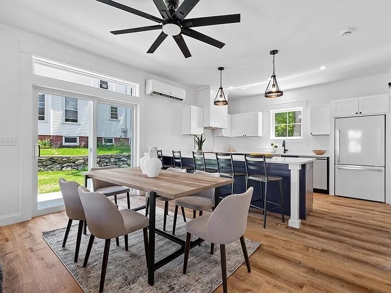 Kitchen with white cabinets and navy island