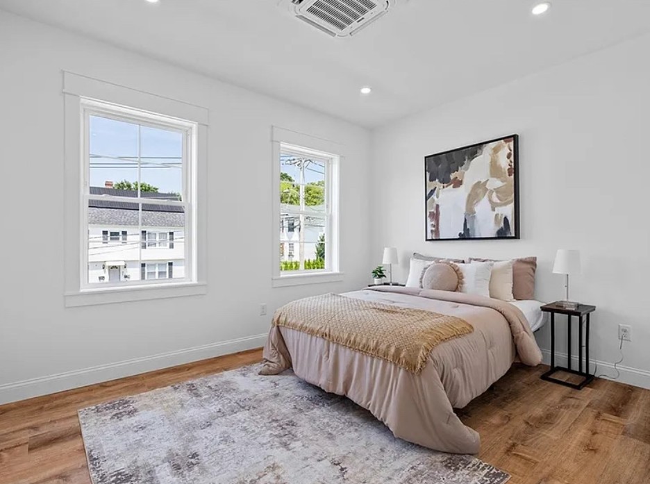Bedroom with neutral bedding and artwork